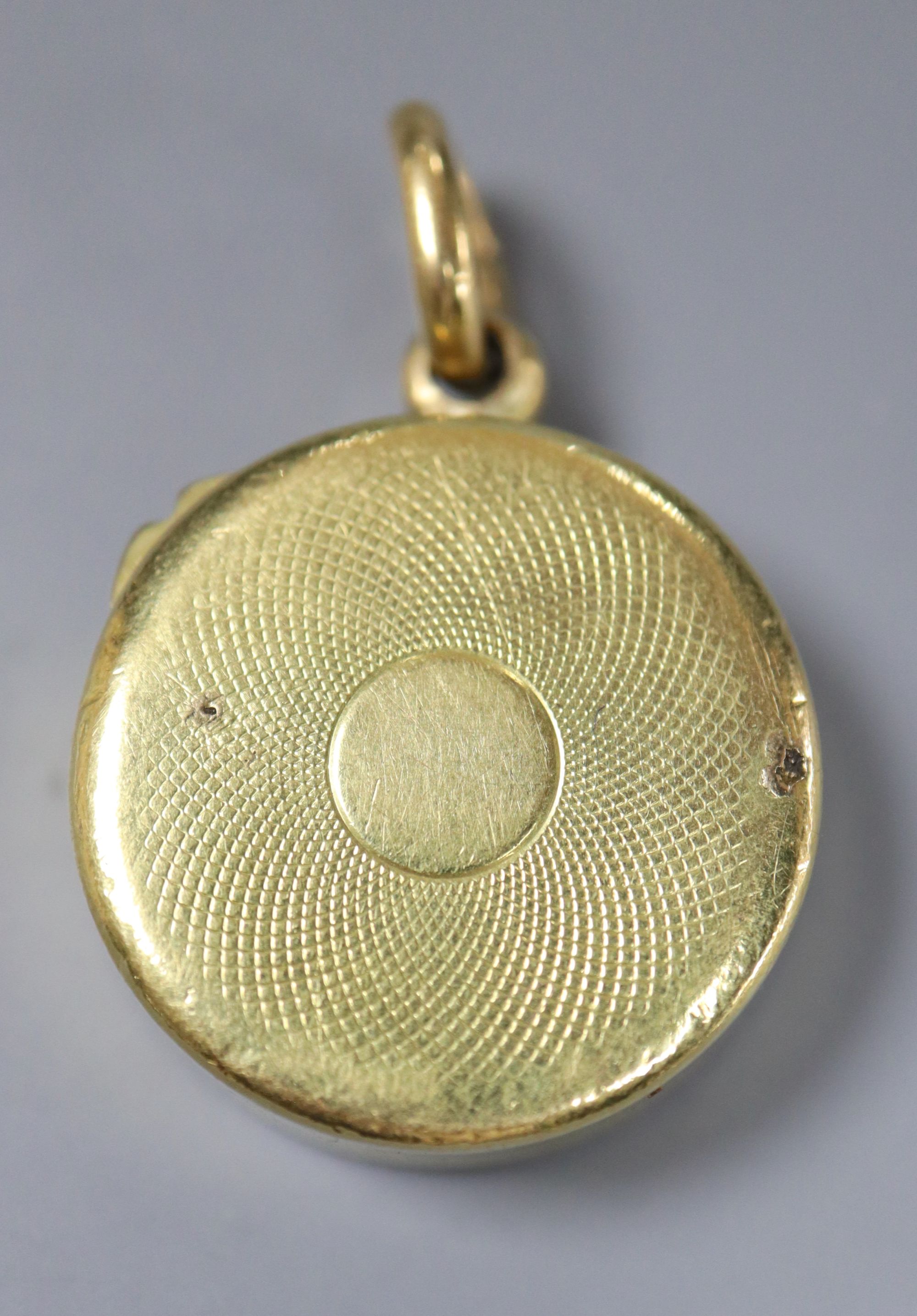 An 18ct cased pendant compass, with bale, 22mm, gross 14 grams.